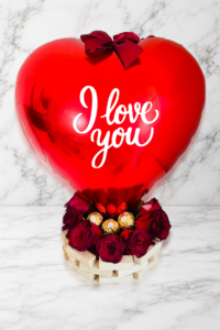 7 roses with heart balloon and 3 ferrero rochers.
