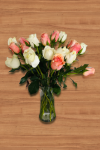 peach and white roses in a clear white glass